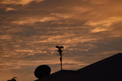 Low angle view of street light against cloudy sky