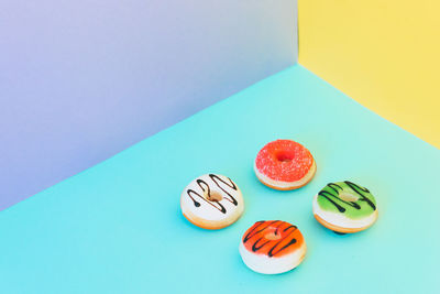 High angle view of cupcakes on table against blue background