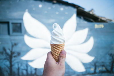 Close-up of hand holding ice cream