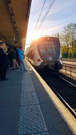 Train on railroad station platform in city against sky