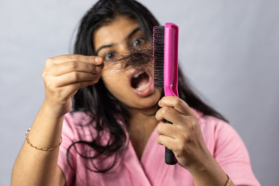 Close-up of woman holding thermometer