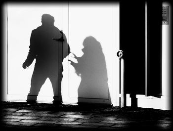 Full length of woman standing on wall