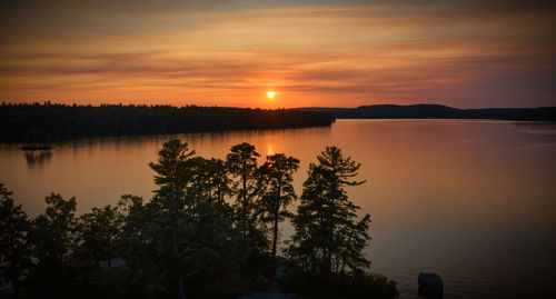 Scenic view of lake against sky during sunset