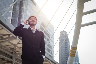 Low angle view of man using mobile phone