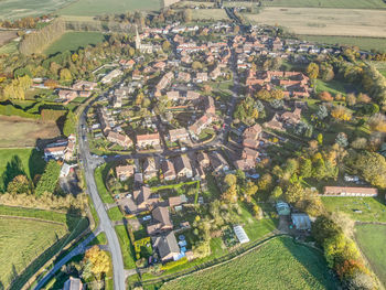 High angle view of trees and houses in field