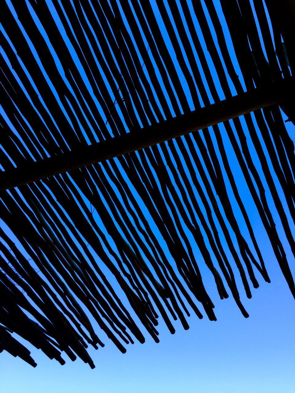 LOW ANGLE VIEW OF BLUE SKY SEEN THROUGH METAL