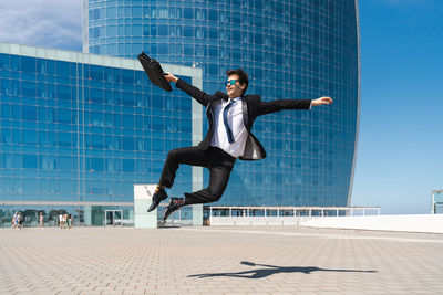 Full length of man jumping on street