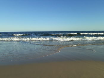 Scenic view of sea against clear blue sky