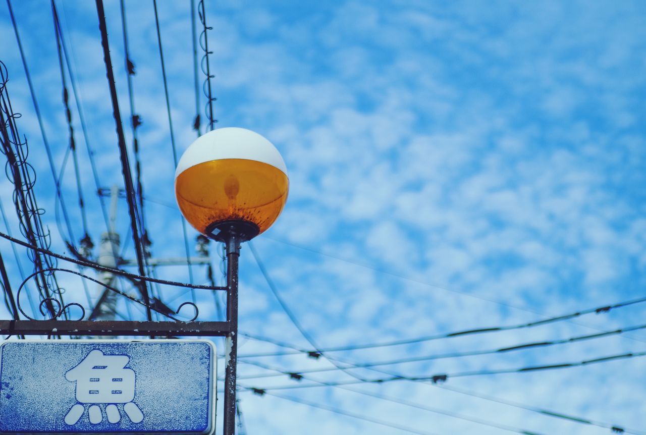 yellow, sky, low angle view, blue, cloud, day, outdoors, focus on foreground, no people, cloud - sky