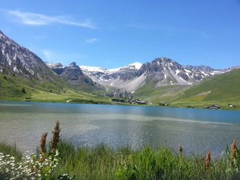 Scenic view of lake and mountains against sky