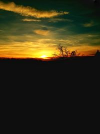 Silhouette landscape against sky during sunset