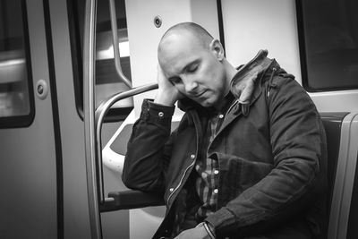 Rear view of man sitting in train