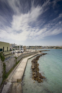 Scenic view of beach against sky in city