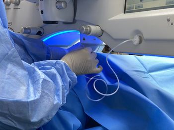 Close-up of human hand on bed
