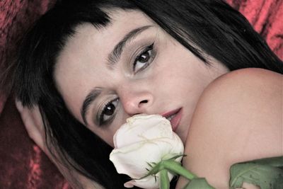 Close-up portrait of woman with flower