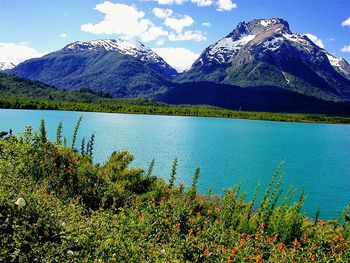 Scenic view of mountains against blue sky