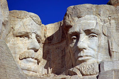 Low angle view of mt rushmore national monument against clear sky