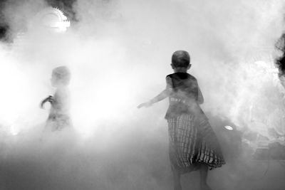 People standing on stage at night