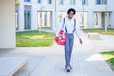 Full length of man standing on skateboard