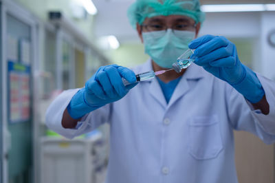 Mid section of a man holding umbrella