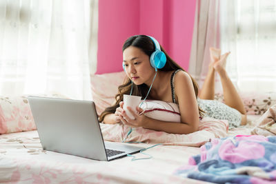 Young woman using laptop at home