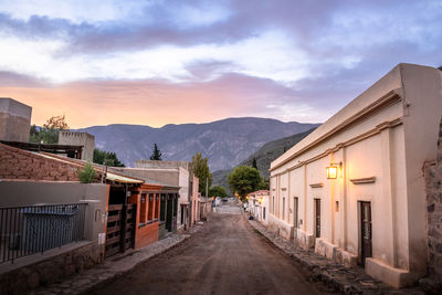 Street amidst buildings against sky