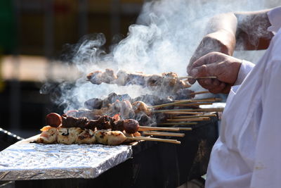 Midsection of venders preparing street food