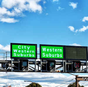 Low angle view of information sign against sky