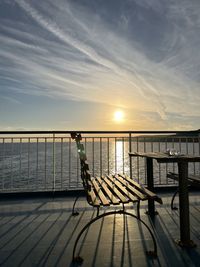 Pier over sea against sky during sunset