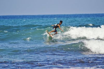 People surfing in sea