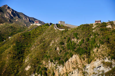 Panoramic view of trees and mountains against clear blue sky