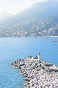 Aerial view of townscape by sea against sky in camogli, italy