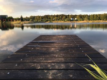 Pier on lake against sky