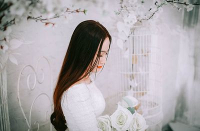 Woman looking at white flowering plants