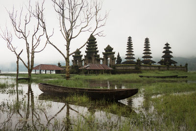 Built structure by lake against sky