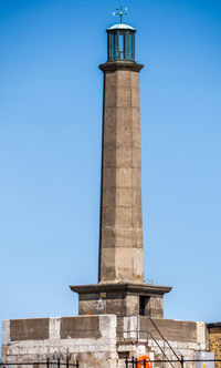 Low angle view of lighthouse against clear blue sky