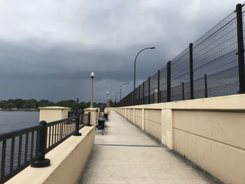 Street lights on bridge against sky