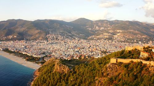 Alanya, turkey. high angle view of townscape and mountains against sky