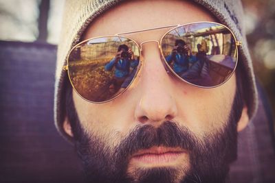 Close-up portrait of young man wearing sunglasses