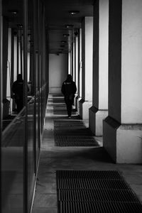 Rear view of woman walking on staircase in building