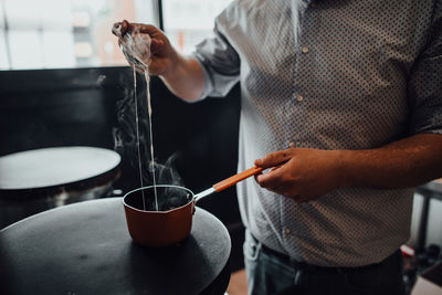 Male chef preparing crepes in restaurant kitchen