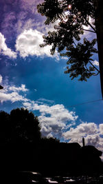 Low angle view of silhouette trees against sky