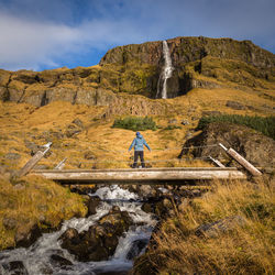 Man standing on rocks against mountains