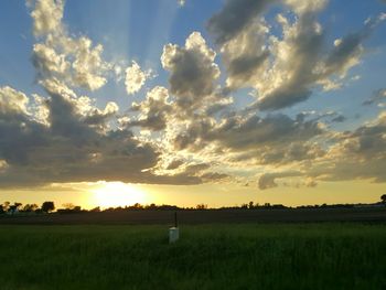 Scenic view of field against sky during sunset