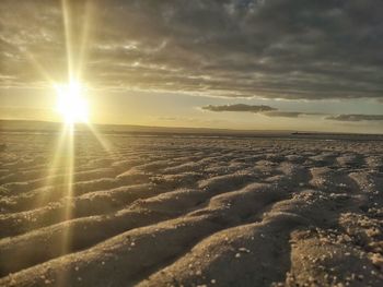 Scenic view of beach against sky during sunset