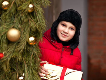 Portrait of smiling boy holding christmas gift