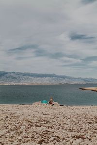 People on beach against sky