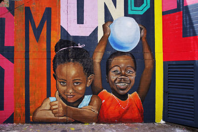 Portrait of boy with graffiti on wall