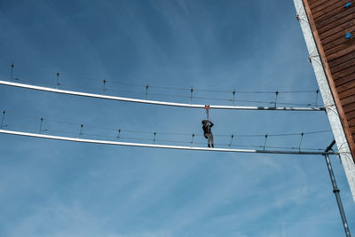 Low angle view of cable car against sky