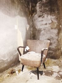 Empty chair in abandoned room